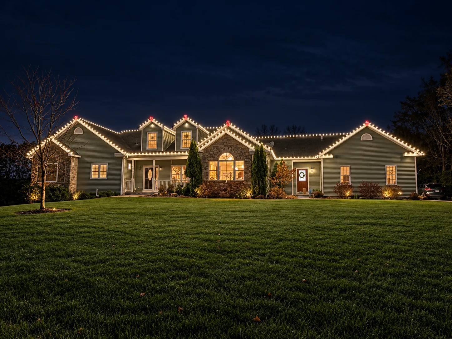 Wide home outlined with warm white holiday roofline lights